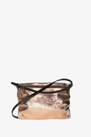 A small metallic rose gold crossbody bag by INA KENT with a black strap and zipper closure. The bag features a slightly crinkled texture and a circular charm hanging from the zipper pull.