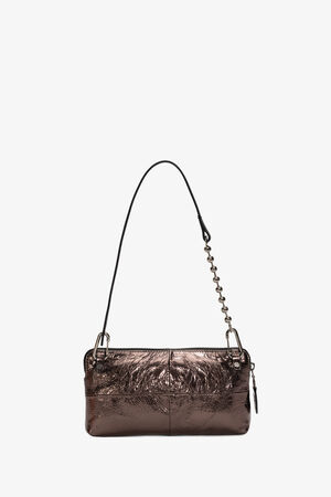 The INA KENT metallic bronze handbag boasts a crinkled texture, complemented by a sleek black adjustable handle. A chic chain detail graces one side, while a secure zipper closure completes the design against a plain white backdrop.
