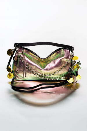 Iridescent handbag by INA KENT with black strap, silver zipper, chain accents, and decorative gold coins and charms attached to the side.