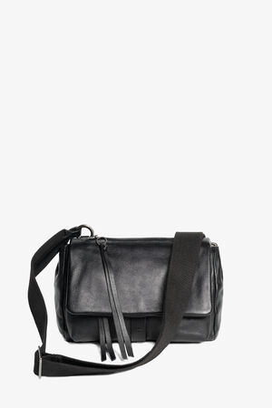 INA KENT black leather crossbody bag with a front flap, two zipper pulls, and an adjustable fabric shoulder strap, displayed against a plain white background.
