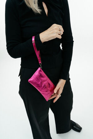 metallic neon pink wallet by INA KENT on wrist