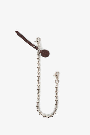 A silver beaded chain with two metal clasps, a round brown INA KENT tag, and a leather strap attached, displayed on a white background.