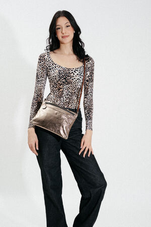 Woman wearing a leopard print long-sleeve top, dark pants, and an INA KENT metallic crossbody bag stands against a plain white background.