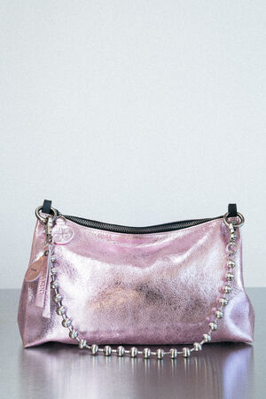 A metallic pink INA KENT handbag with a shiny finish, silver beaded strap, zipper closure, and attached round and rectangular tags, displayed against a light gray background.