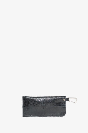 Black rectangular leather pouch by INA KENT with a silver metal clip attached to one end, displayed against a plain white background.