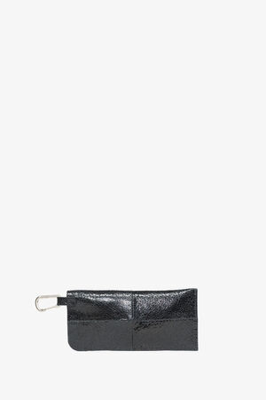 Black rectangular leather pouch by INA KENT with two front pockets and a silver metal clasp attached to one end, displayed on a plain white background.
