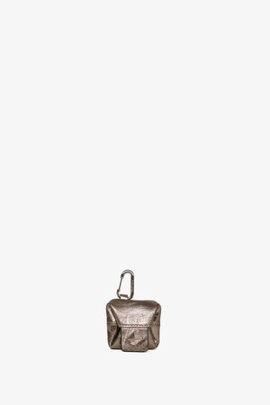 A small metallic pouch by INA KENT, featuring a front pocket and a carabiner clip attached at the top, displayed against a plain white background.