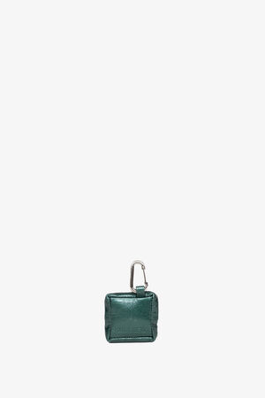A small, square, dark green leather pouch by INA KENT with a silver carabiner clip attached at the top, displayed on a plain white background.