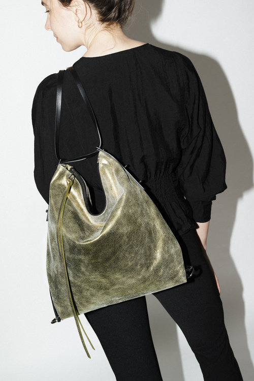 Spacious, practical tote bag made of green metallic leather worn as backpack AMPLE ed.1 crackled kiwi