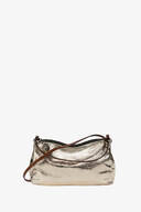 An INA KENT metallic gold handbag, featuring a brown strap and a zipper closure, is elegantly displayed against a plain white background.