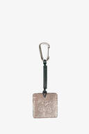 A rectangular metallic keychain with an embossed INA KENT design, attached to a dark strap and a metal carabiner clip, set against a plain white background.