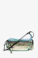 An INA KENT rectangular metallic green leather crossbody bag with a front zipper pocket, decorative tags, and a black adjustable strap, photographed against a plain white background.
