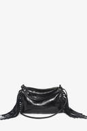 An INA KENT black leather crossbody bag with side fringe detailing, a top zipper closure, and a thin shoulder strap is elegantly displayed against a plain white background.